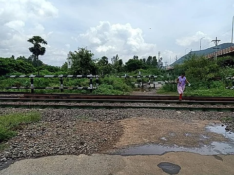 A woman crosses the railway track at Lankelapalem where construction of an RUB was approved.