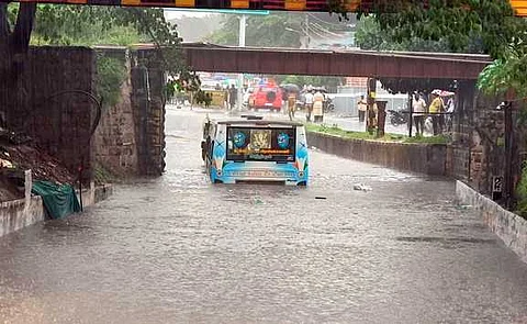 கோவை சிவானந்தா காலனி அருகே ரயில்வே பாலத்தின் கீழ்ப்பகுதியில் தேங்கிய மழைநீரில் சிக்கிய தனியாா் பேருந்து.