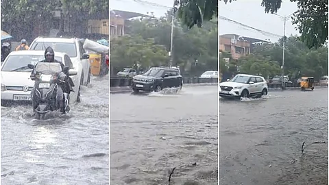 கனமழையால் சாலையில் தேங்கிய மழைநீரில் தத்தளித்தபடி செல்லும் வாகனங்கள்