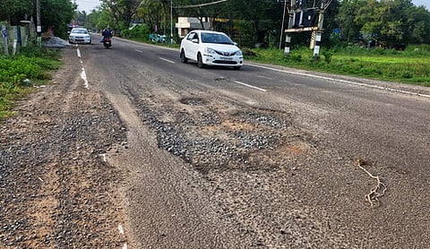 அண்மையில் பெய்த மழையால் சேதமடைந்து காணப்படும் திருநள்ளாறு - அம்பகரத்தூா் பகுதி சாலை.