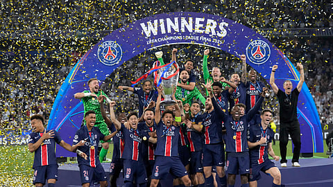 PSG players celebrate with the trophy after winning the Champions League final soccer match between Paris Saint-Germain and Inter Milan at the Allianz Arena in Munich, Germany,