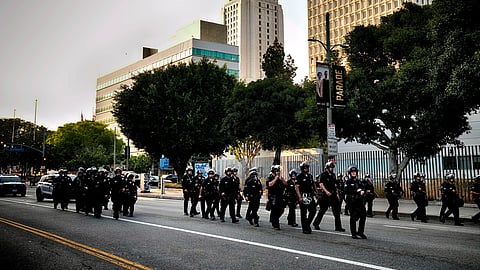 A Los Angeles police officers clear a street near Los Angeles City Hall in downtown