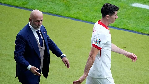 Poland's Robert Lewandowski, right, walks by Poland' head coach Michal Probierz, left, during a Group D match between Poland and Austria at the Euro 2024 soccer tournament in Berlin,