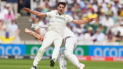 Australia's captain Pat Cummins, front, collides with South Africa's Kyle Verreynne while appealing for Verreynne's wicket on day two of the World Test Championship final
