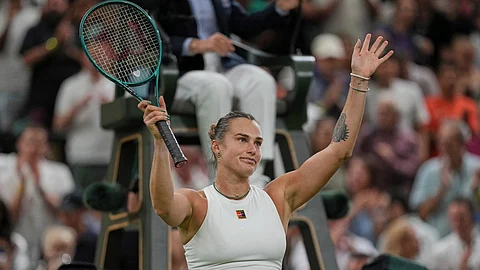 Aryna Sabalenka of Belarus celebrates after beating Emma Raducanu of Britain to win a third round women's singles match at the Wimbledon