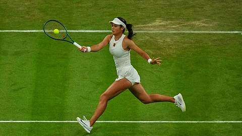 Emma Raducanu of Britain returns to Aryna Sabalenka of Belarus during a third round women's singles match at the Wimbledon Tennis Championships in London