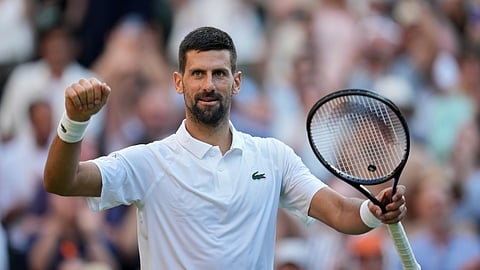 Serbia's Novak Djokovic celebrates after beating Italy's Flavio Cobolli during a quarterfinal men's singles match at the Wimbledon Tennis Championships in London