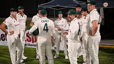 Australia's players huddle before bowling against West Indies on day one of the third Test cricket match at Sabina Park in Kingston, Jamaica,