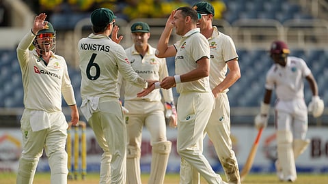 Australia's Scott Boland celebrates with Sam Konstas running out West Indies' Justin Greaves on day two of the third Test cricket