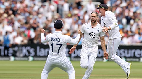 England's Chris Woakes, center, celebrates with teammates after the dismissal of India's Nitish Kumar Reddy