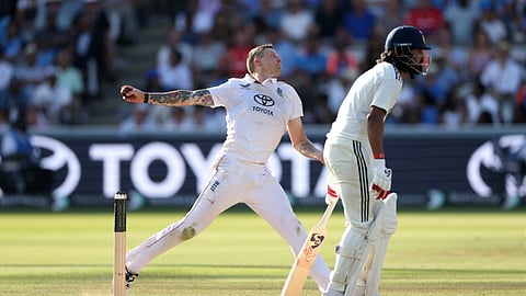 England's Brydon Carse, left, bowls a delivery during the fourth day of the third cricket test match between England and India at Lord's cricket ground in London,