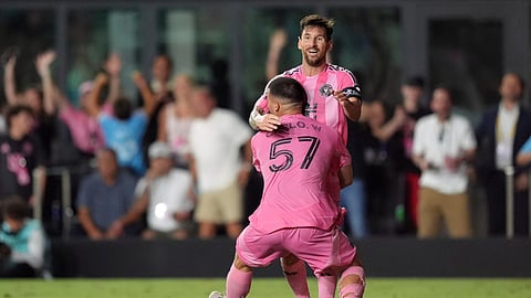 Inter Miami defender Marcelo Weigandt (57) lifts teammate forward Lionel Messi