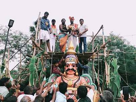 முனீஸ்வரனுக்கு புனித நீரை ஊற்றி கும்பாபிஷேகத்தை நடத்தி வைத்த சிவாச்சாரியா்.