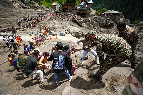 கிஷ்த்வாரில் மண்சரிவு ஏற்பட்ட பகுதியில் சிக்கியவா்களை மீட்கும் பணியில் ஈடுபட்ட பாதுகாப்புப் படையினா். ~ஜம்மு-காஷ்மீரின் கிஷ்த்வாரில் வெள்ளம்-மண்சரிவால் சேதமடைந்த வீடு, வாகனங்கள்.