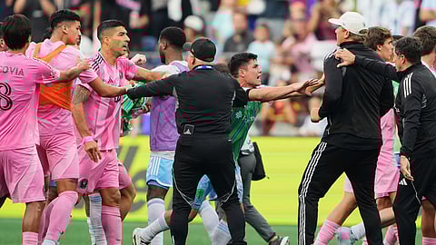 Inter Miami forward Luis Suárez, third from left, is separated from Seattle Sounders players and staff as Sounders midfielder Kalani Kossa-Rienzi, center right facing, holds a staff member back during a fight