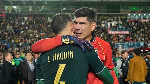 Bolivia's goalkeeper Carlos Lampe and teammate Luis Haquin celebrate their team's 1-0 victory over Brazil at the end of a World Cup 2026 qualifying