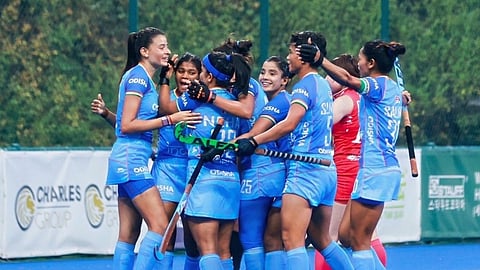 The Indian women's hockey team celebrates after scoring a goal.