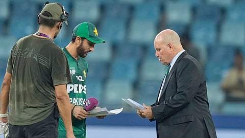 Pakistan's captain Salman Agha shares team list with match referee Andy Pycroft at the toss during the Asia Cup cricket match between Pakistan and United Arab Emirates at Dubai.