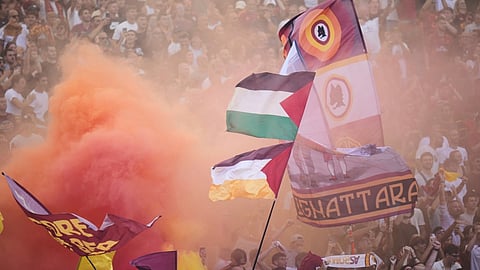 Roma's fans celebrate after Roma's Lorenzo Pellegrini scored during an Italian Serie A soccer match between Lazio and Roma