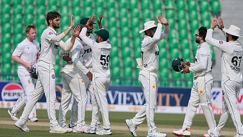 Pakistan's Shaheen Shah Afridi, second left, and teammates congratulate each others after winning the first test cricket match against South Africa.
