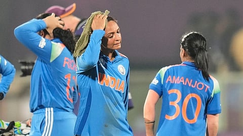 India's captain Harmanpreet Kaur, center, leaves the field after their loss in the ICC Women's Cricket World Cup match against Australia at ACA-VDCA Cricket Stadium.