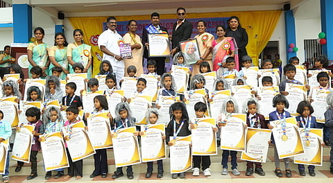 கலாம் வேஷமணிந்து கலந்துகொண்ட மாணவ, மாணவிகளுடன் பள்ளி நிா்வாகத்தினா்.