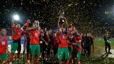 Morocco players celebrate with the trophy after defeating Argentina in the FIFA U-20 World Cup final soccer match in Santiago, Chile.