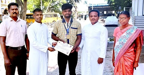 மாநில பளு தூக்கும் போட்டியில் தங்கப்பதக்கம் வென்ற மாணவா் கருப்பசாமியை பாராட்டிய பள்ளி தாளாளா் பங்குத்தந்தை அருள்ராஜ் அடிகளாா். உடன் உதவி பங்குத்தந்தை குழந்தைராஜ் அடிகளாா்.