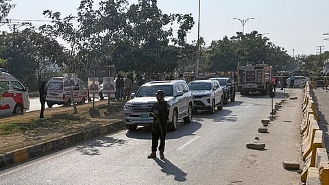 Pakistani security officials stand guard after a powerful car bomb exploded outside a district court in Islamabad, Pakistan, Tuesday.