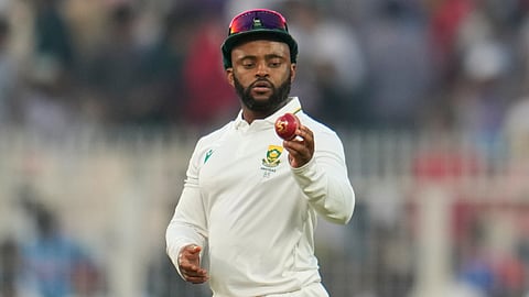 South Africa's captain Temba Bavuma looks at the ball at the end of play on the first day of the first cricket test match in Kolkata.