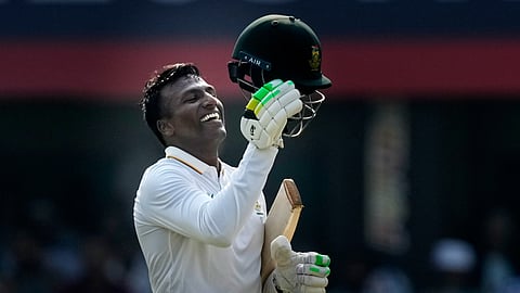 South Africa's Senuran Muthusamy celebrates after scoring a century on the second day of the second cricket test match in Guwahati.