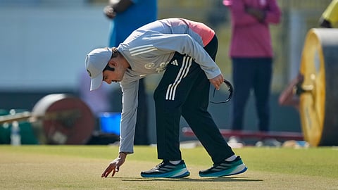 India's chief coach Gautam Gambhir examines the pitch ahead of the second test match between India and South Africa in Guwahati