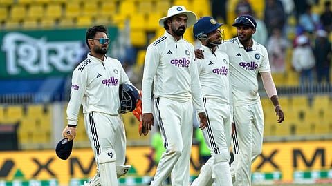 India's players walk off the field at the end of the third day of the second cricket test match between India and South Africa in Guwahati.