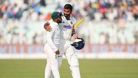 India's Jasprit Bumrah, right, speaks to South Africa's captain Temba Bavuma as the leave the field at the end of the game on the third day of the first cricket test match in Kolkata.