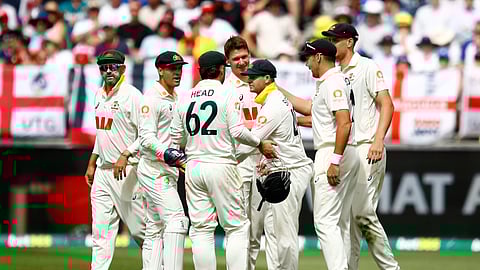 Australia's players celebrate the wicket of England's Jofra Archer on day two of the first Ashes cricket test match between Australia and England in Perth
