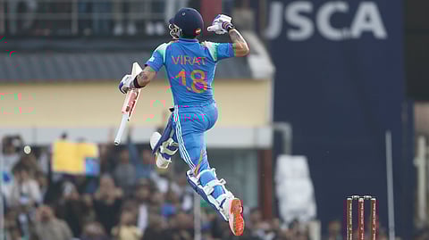 Virat Kohli celebrates after scoring a century