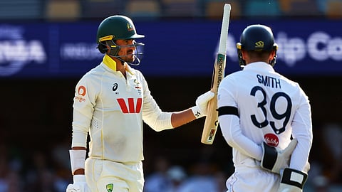 Australia's Mitchell Starc, left, celebrates his fifty runs during the second Ashes cricket test match between Australia and England in Brisbane,