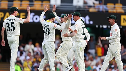 Australia's players celebrate the wicket of England's Jamie Smith during the second Ashes cricket test match between Australia and England in Brisbane