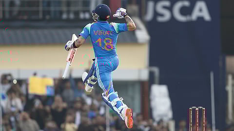 Virat Kohli celebrates after scoring a century