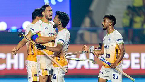 The Indian team celebrates after scoring a goal.