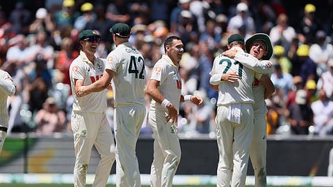 Australia's players celebrate after winning the third Ashes Test against England in Adelaide, Australia.