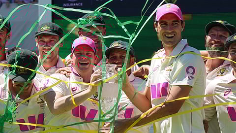 Australia's Pat Cummins and Steve Smith celebrate with the trophy following play on get last day of the fifth and final Ashes cricket test between England and Australia i
