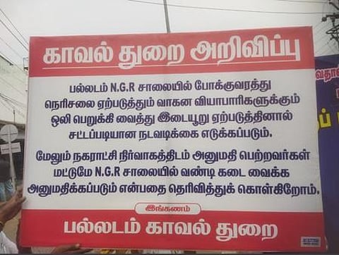 பல்லடத்தில் தியாகி என். ஜி.ஆா். சாலையில் போலீஸாா் வைத்துள்ள எச்சரிக்கை அறிவிப்பு.