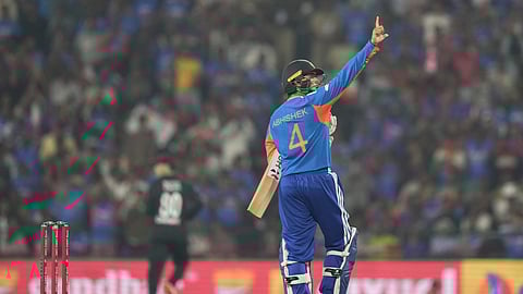 India's Abhishek Sharma celebrates after scoring fifty runs during the first T20 cricket match between India and New Zealand in Nagpur, India.