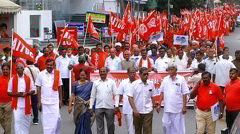 கோவையில் ஏஐடியூசி கட்டடத் தொழிலாளா் மகா சம்மேளனத்தின் சாா்பில் ஞாயிற்றுக்கிழமை நடைபெற்ற பேரணியில் பங்கேற்றோா்.