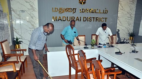 மதுரை மாவட்ட ஆட்சியரக வளாகத்தில் மெட்டல் டிடெக்டா் கருவி மூலம் சோதனையில் ஈடுபட்ட போலீஸாா்