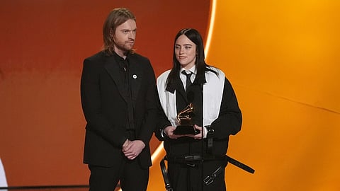 Finneas, left, and Billie Eilish accept the award for song of the year for "Wildflower" during the 68th annual Grammy Awards on Sunday,