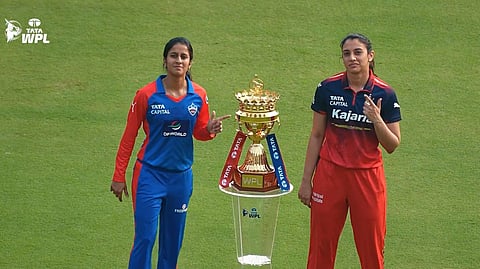 Jemimah Rodrigues and Smriti Mandhana near the WPL trophy.