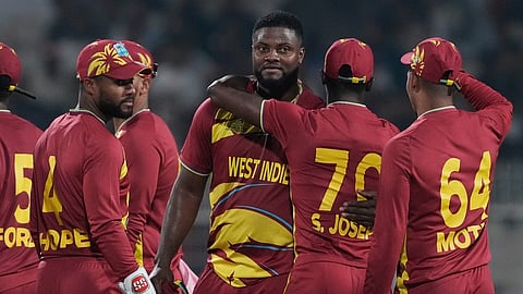 West Indies' Romario Shepherd ,third from right, celebrates with teammates after taking five-wicket in the match during the T20 World Cup cricket match between Scotland and West Indies in Kolkata