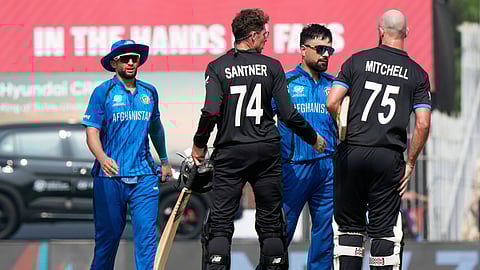 Afghanistan's captain Rashid Khan, center, greets New Zealand's Daryl Mitchell, right, and Mitchel Santner after New Zealand won their T20 World Cup cricket match against Afghanistan in Chennai,